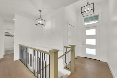 Entryway featuring a chandelier and light wood finished floors