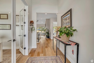 Entry featuring light wood finished floors and recessed lighting