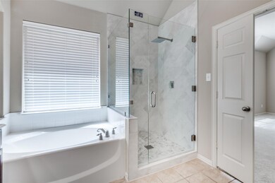 Bathroom featuring separate rain shower and bath a