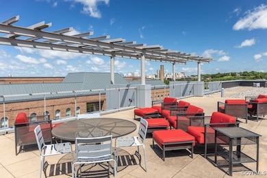 View of patio with outdoor dining space, a pergola