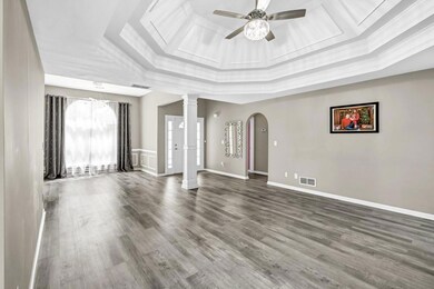 Unfurnished living room with crown molding, visibl