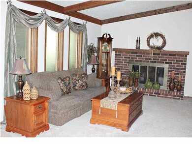 LIVING ROOM BOASTS A WOODBURNING FIREPLACE WITH GL