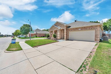 Ranch-style house with a front lawn, a garage, and