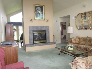 Gas fireplace accents the cathedral ceiling in thi