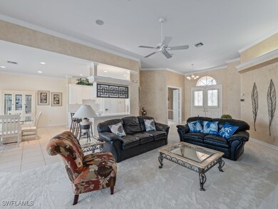 Tiled living room with ceiling fan with notable ch