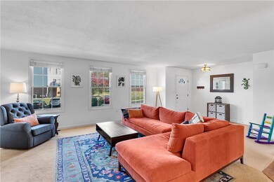 The living room offers tons of sunshine, full of n