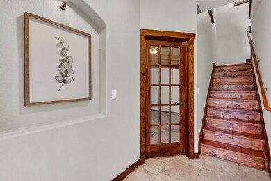 The entryway showcases a warm wood door with decor