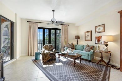 Living room featuring ceiling fan, french doors, a