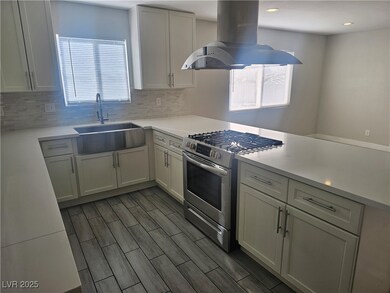 Kitchen featuring stainless steel gas range oven,