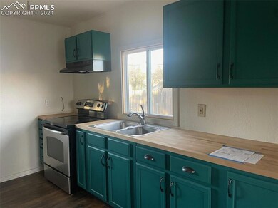 Kitchen with dark hardwood / wood-style flooring, 