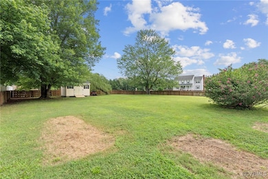 Fenced backyard with a storage shed