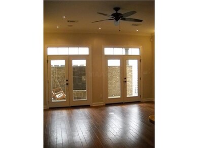 Double doors lead out to covered patio from living