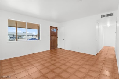 Living room showing the front door and entryway