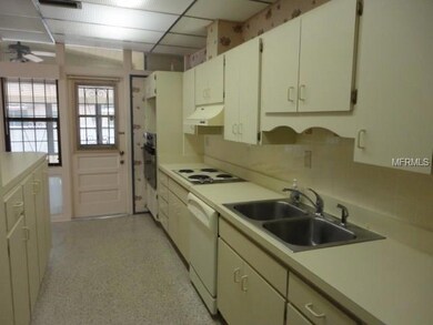 Galley kitchen with plenty of cabinet space.  Opens up into living/dining room combo.