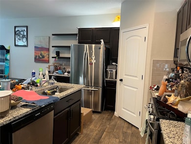 Kitchen featuring stainless steel appliances, dar
