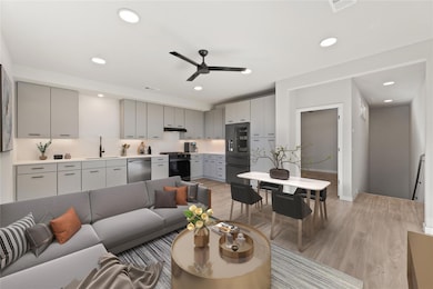 Living room with light wood-style flooring, a cei