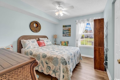 Bedroom featuring a textured ceiling, wood finishe