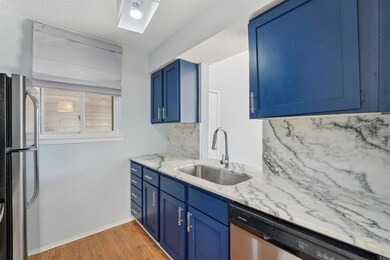 Kitchen with blue cabinetry, stainless steel appl