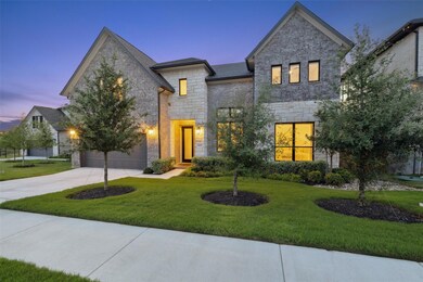 View of front of home featuring stone siding, dri