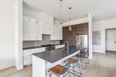 A chef’s dream kitchen with quartz countertops, a