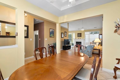 Tiled dining area featuring ceiling fan