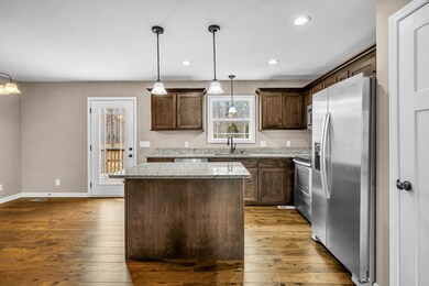 The kitchen exudes sophistication with its separate island and luxurious granite countertops, providing ample space for both cooking and casual dining. 418 N Ballard Rd  Manchester, TN 37355