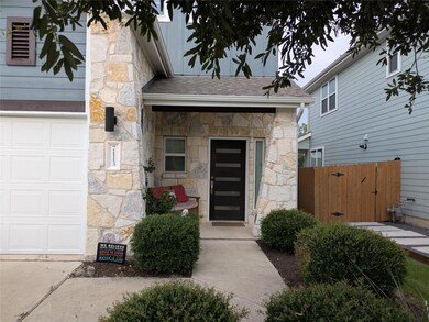 View of exterior entry featuring a garage, stone 