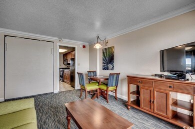 Dining area featuring crown molding, light tile pa