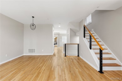 Unfurnished living room featuring light wood-style