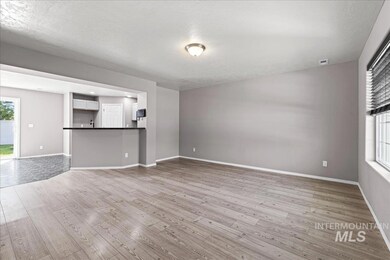 Unfurnished living room featuring wood finished floors and a textured ceiling