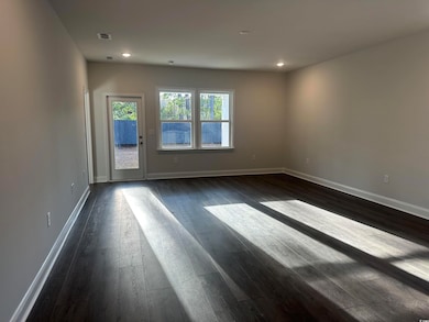 Unfurnished room with dark wood-type flooring