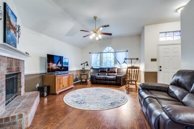 Living room with hardwood / wood-style flooring, a