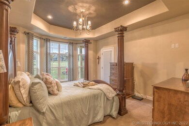Elegant master bedroom with access to back patio.