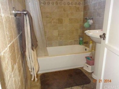 VIEW OF BATHROOM WITH TRAVERTINE FLOORS AND WALLS