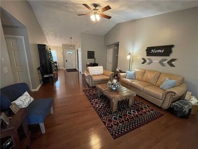 Spacious Living Room with beautiful hard wood flooring and wood fireplace.