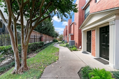 Enjoy a quiet stroll to your front door along a beautifully maintained walkway framed by mature trees and lush greenery.