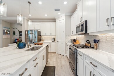 Kitchen featuring stainless steel appliances, a si