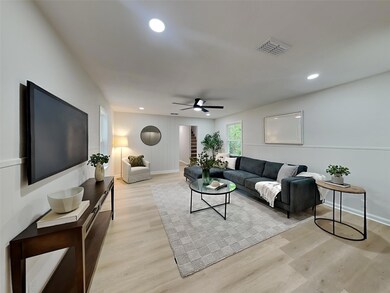 Living area featuring baseboards, recessed lightin