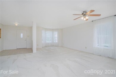 Living room with open sight lines to foyer and din