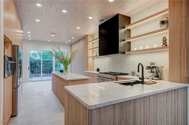 Kitchen featuring modern cabinets, appliances with