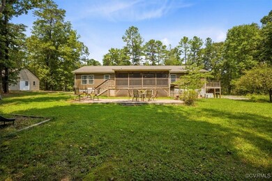 Rear view of property with a yard and a Patio