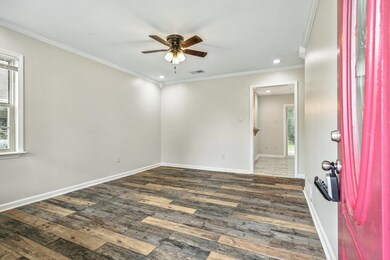 Empty room with dark wood-type flooring, ceiling f