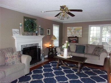 Living Room includes beautiful wood-burning fireplace, hardwood floors and great light!