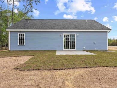 Back of property featuring a patio area, a shingled roof, and a lawn