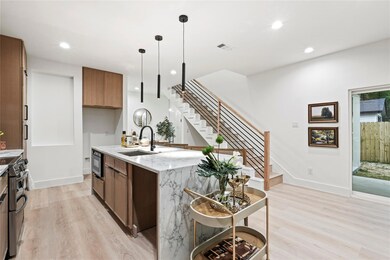 Kitchen featuring light wood finished floors, a si