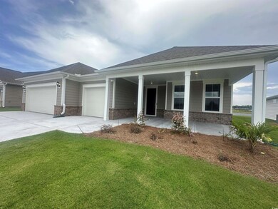 View of front of property with a porch, a garage, 