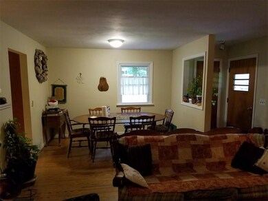 VIEW OF THE OPEN DINING ROOM AREA TO THE LIVING RO