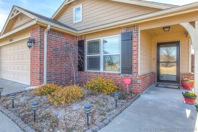 Nice landscaping and a covered front porch welcome
