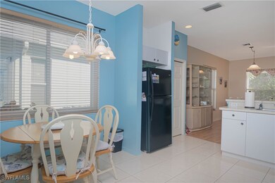 Tiled dining space featuring a chandelier and sink