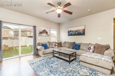 Living room with hardwood floors and ceiling fan.